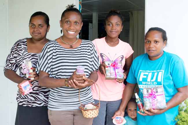 Rona Garae and her staff posing with their products