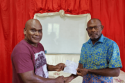 NISCOL Accountant presenting cheques for Vanuatu Government’s share and concession payment to Government’s Board of Directors representative.